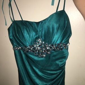 A blue floor length spaghetti strap dress.